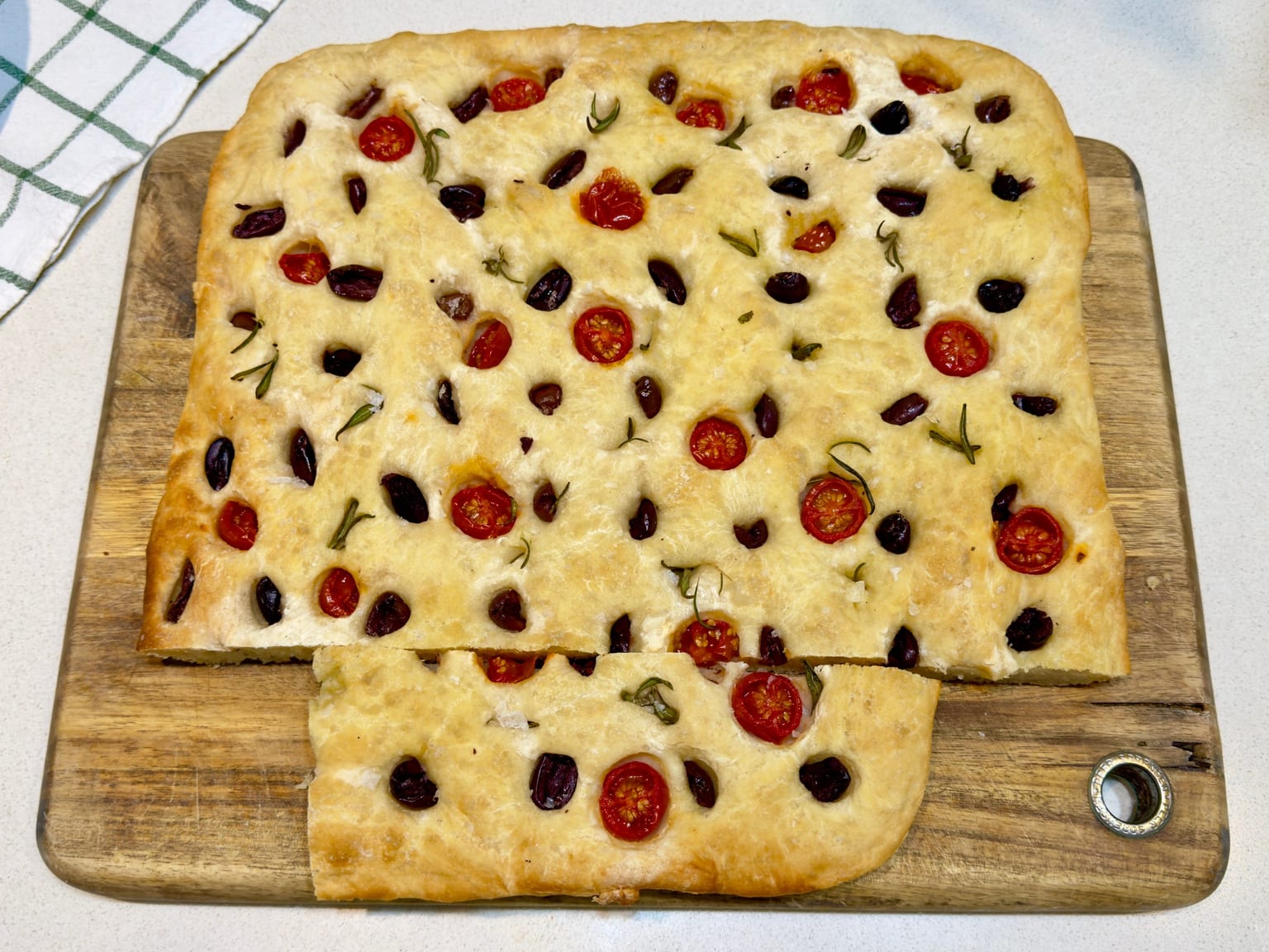 Cherry tomato and oregano focaccia served as a natural-light editorial food photograph