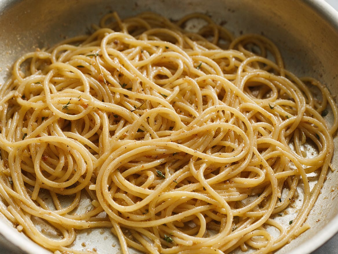 Spaghetti coated in a fluid glossy brown butter and Parmigiano emulsion