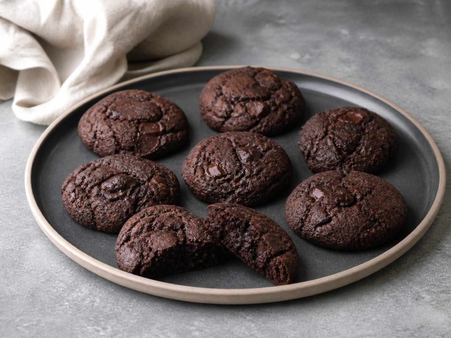 Fudgy dark cocoa cookies with rough pieces of melted dark chocolate
