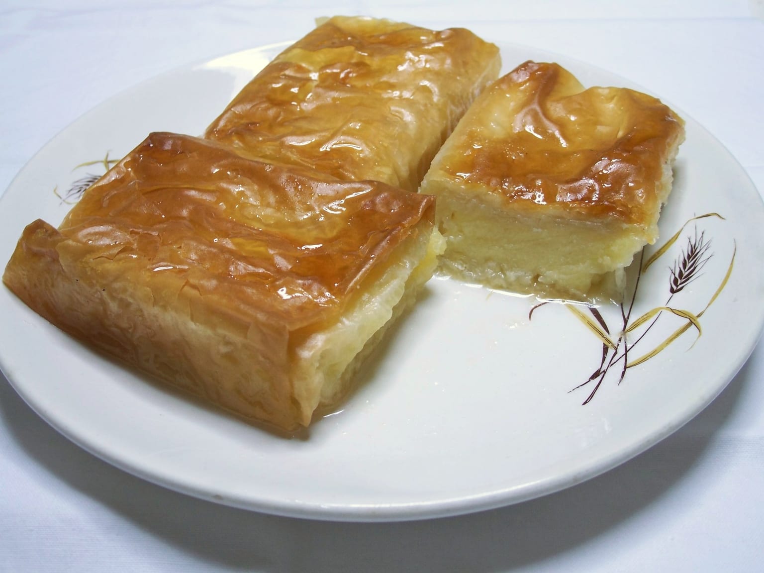 Galaktoboureko: Greek semolina custard filo pie served as a natural-light editorial food photograph
