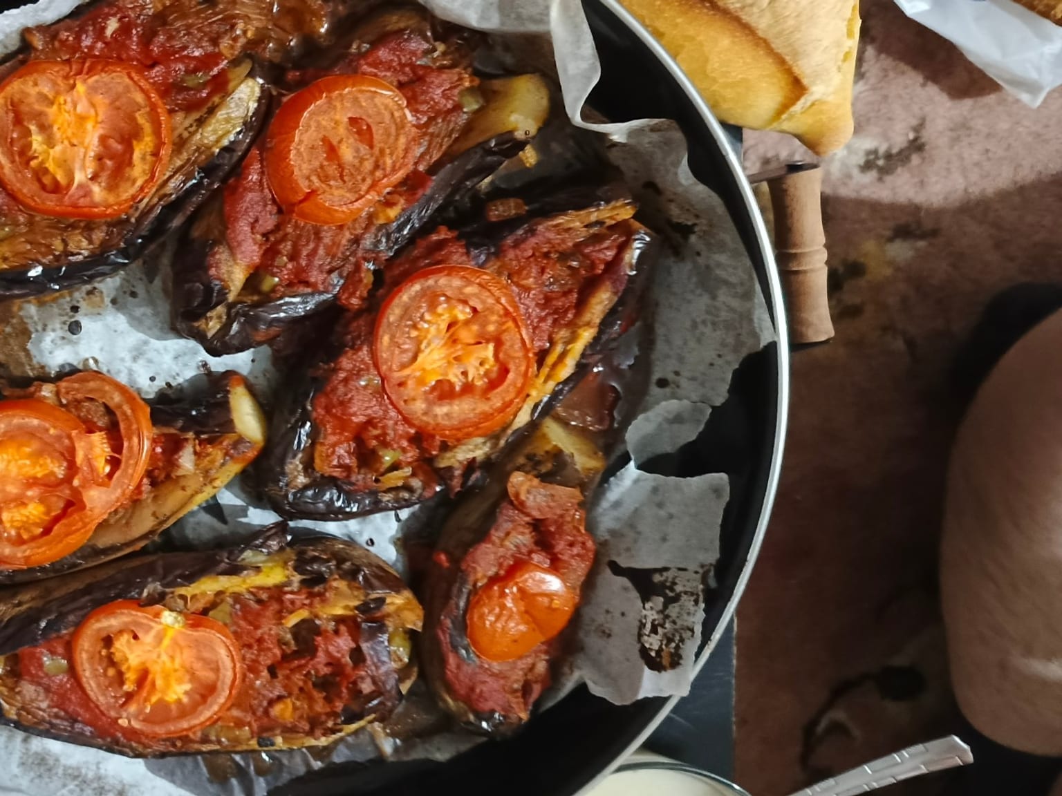 İmam bayıldı: Turkish stuffed aubergines served as a natural-light editorial food photograph