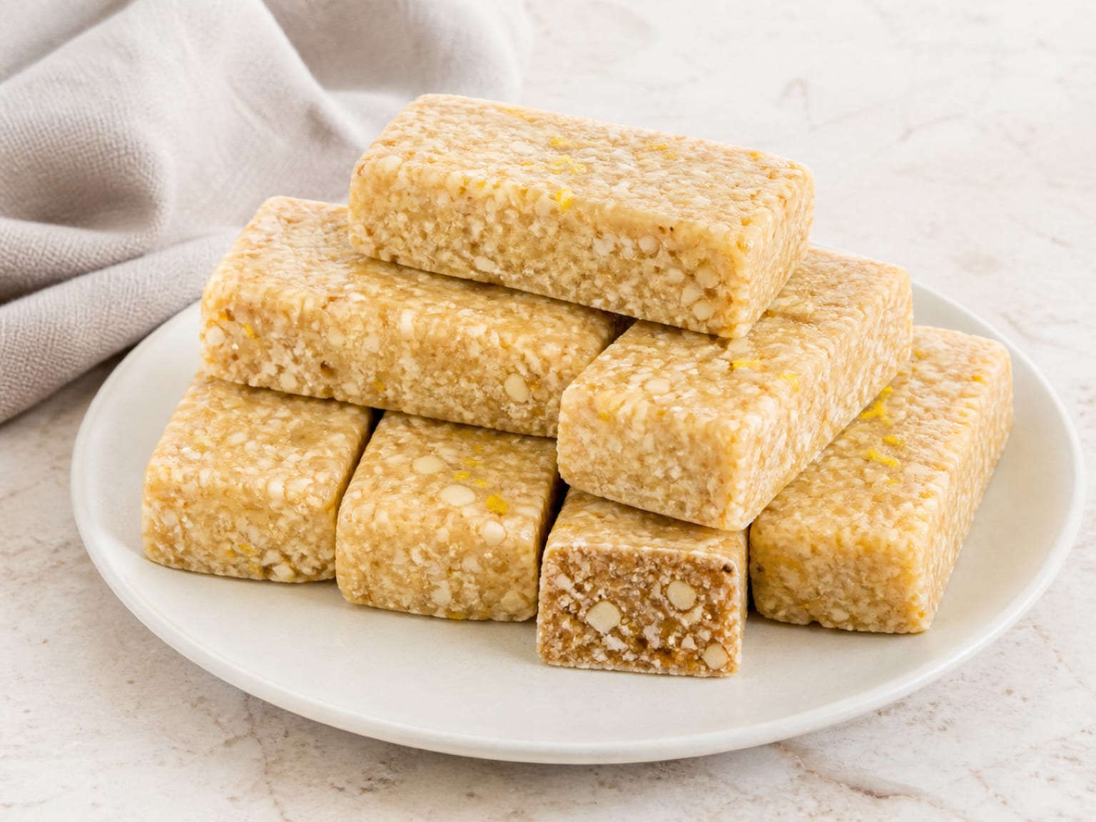 Pale lemon cashew bars with fine coconut and flecks of fresh lemon zest