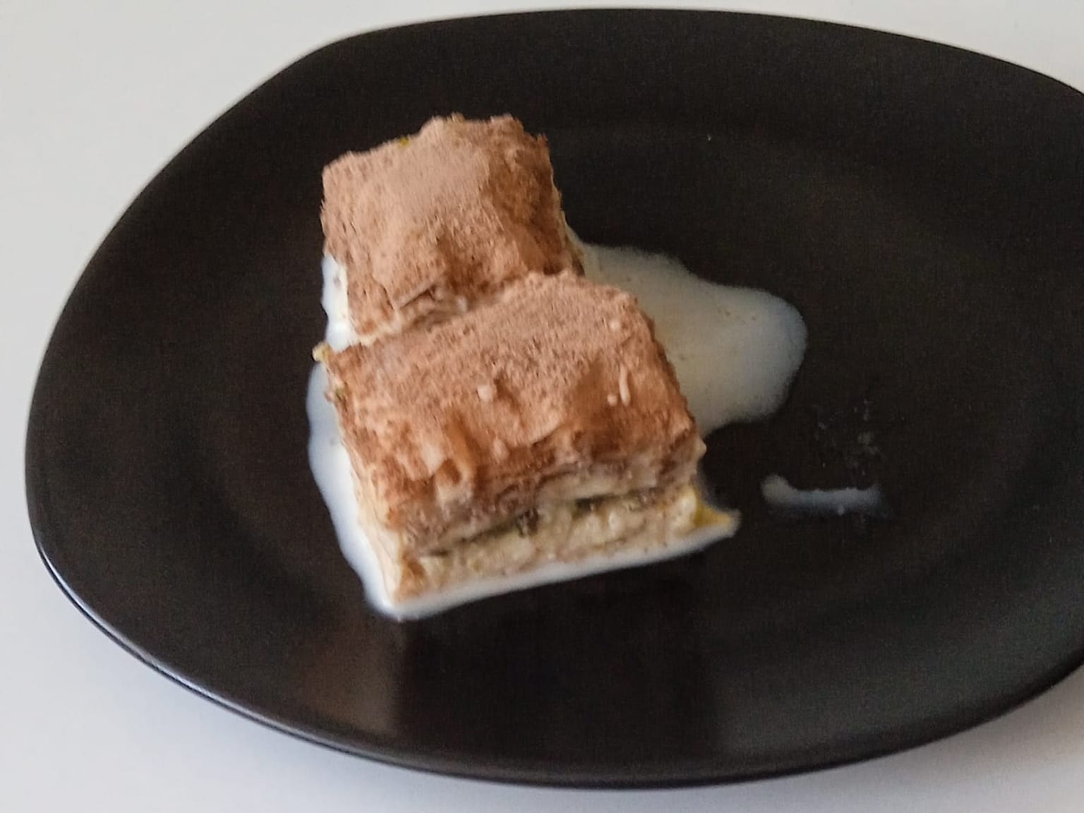 Soğuk baklava: Turkish cold milk baklava served as a natural-light editorial food photograph